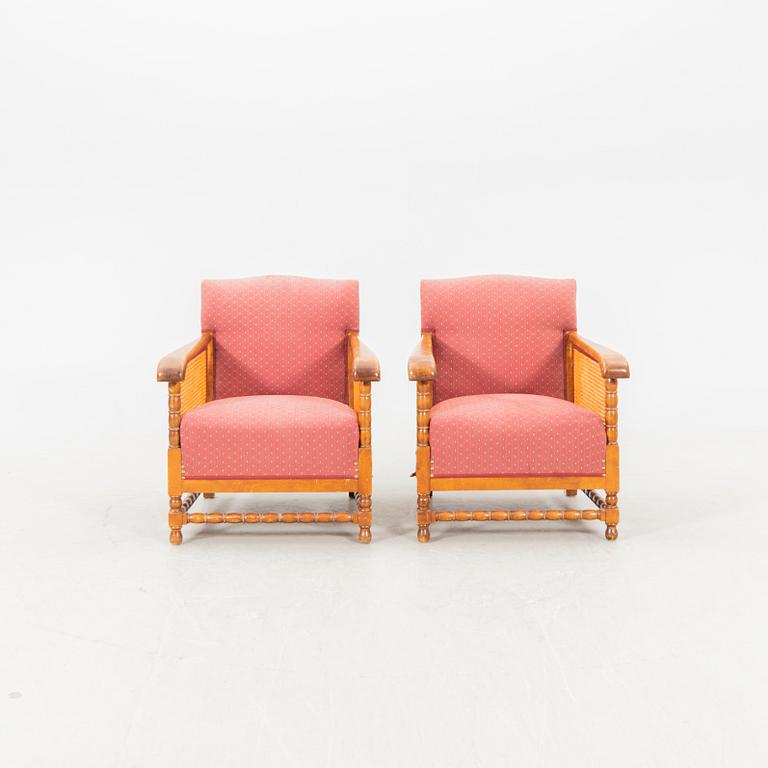 A pair of lacquered wood and rattan easy chairs from the middle of the 20th century.