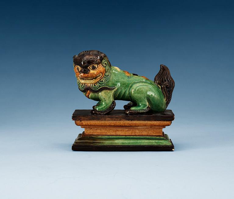 A green, yellow and aubergine glazed figure of a dog, Qing dynasty, 19th Century.