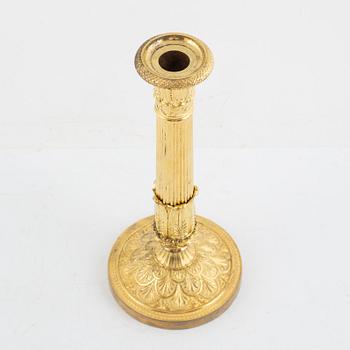 A French Empire gilt-bronze candlestick, early 19th century,