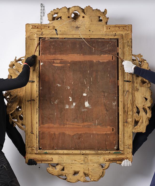 A presumably Dutch Louis XIV carved giltwood frame with mirror glass, in the style of Jean Le Pautre, late 17th century.