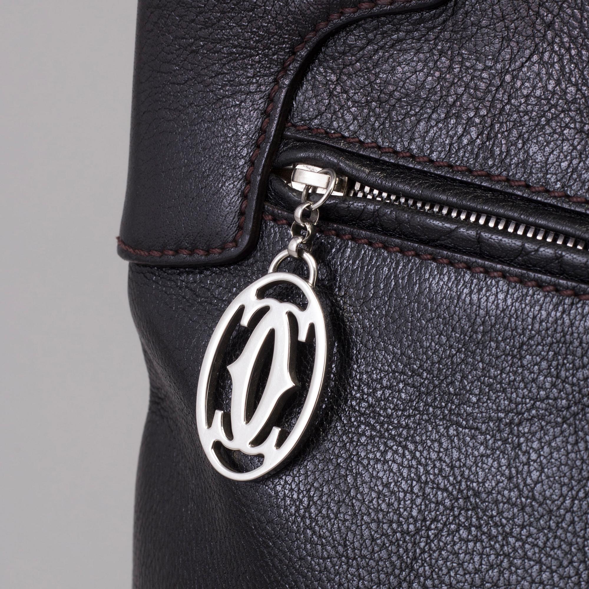 A bag "Marcello Reporter" by Cartier.