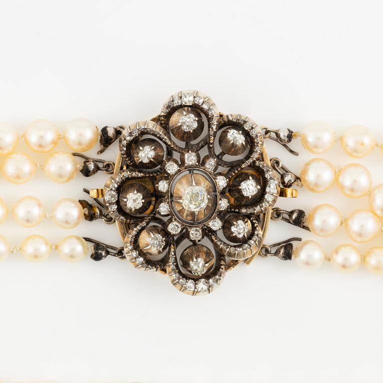 Multi-strand pearl necklace with a clasp/brooch in gold with diamonds,.