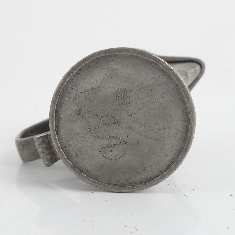A pewter measuring cup by an unidentified master, dated 1766.