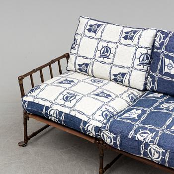 A contemporary bamboo imitating garden sofa.