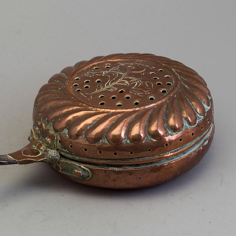 A 18th century copper bed warmer.