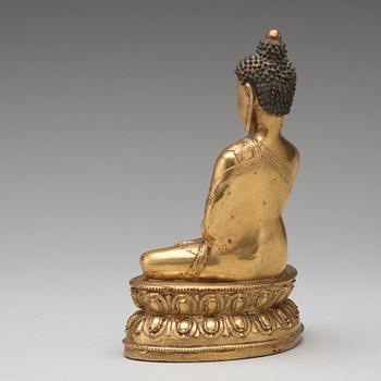 A gilt copper alloy figure of Akshobhya, Tibet, 16th Century.
