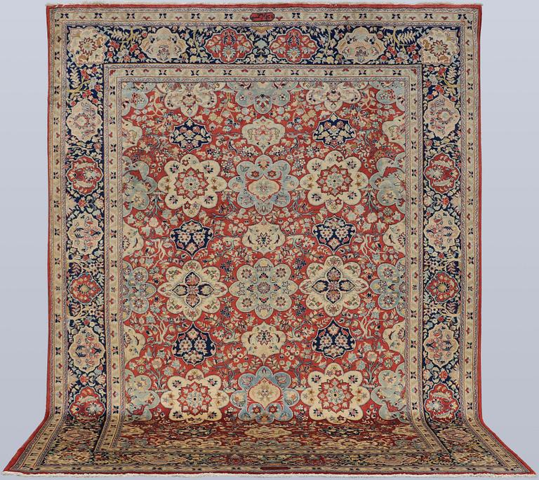A Sarouk carpet, signed, approx. 327 x 253 cm.