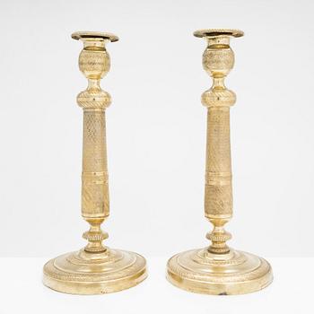 A pair of early 19th century French gilded Empire candlesticks.