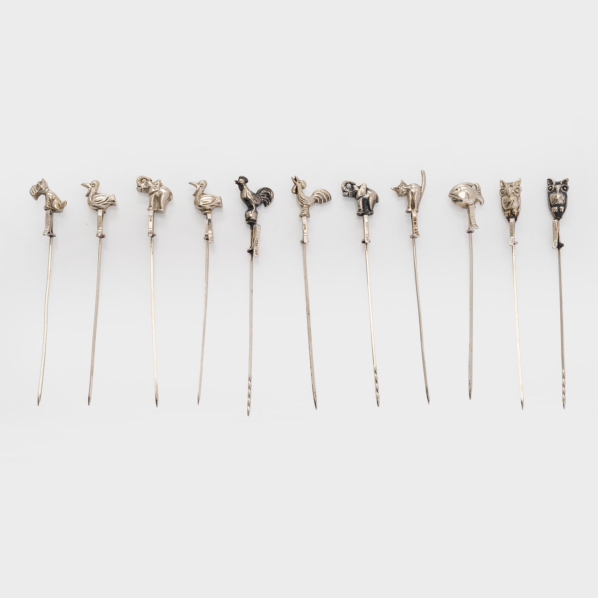 A set of twelve silver coasters and cocktail sticks 11 pcs,  Suomen Kultaseppä Oy 1935 and Kultakeskus 1983.