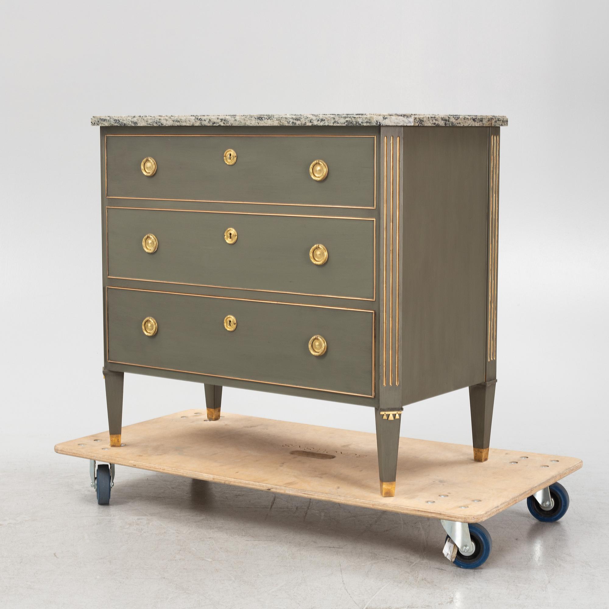 A painted Gustavians style chest of drawers with stone top, first part of the 20th Century.
