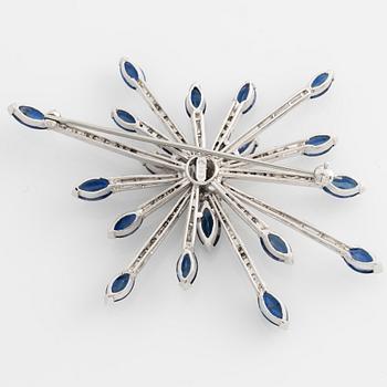 Brooch in 14K white gold with round brilliant, baguette, and navette-cut diamonds and navette-shaped sapphires.