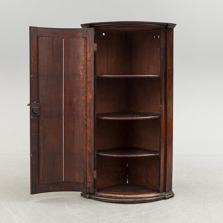 A 19th century corner cabinet.