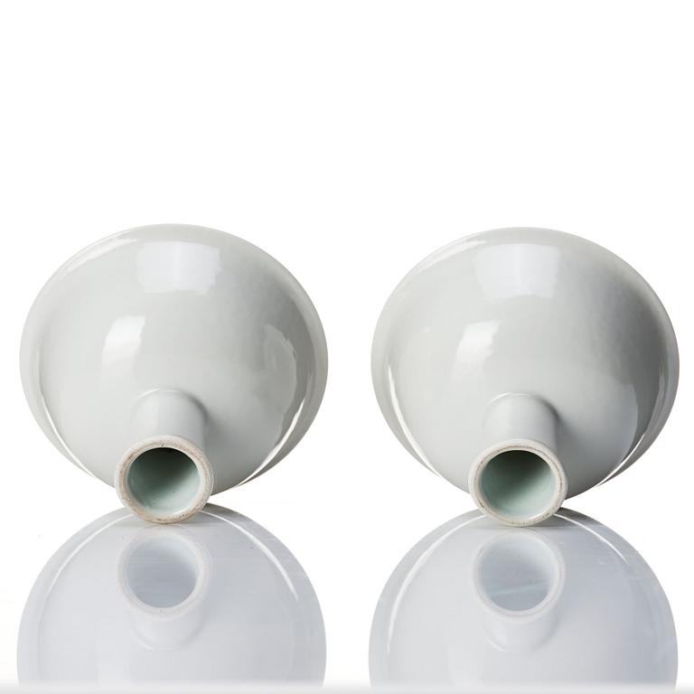 A pair of white glazed anhua stemcups, Qing dynasty, 19th Century.