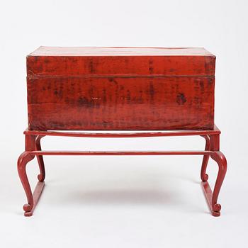 A red lacquered chest on a later stand, late Qing dynasty, 19th Century.