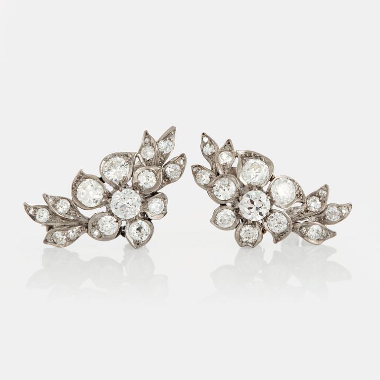 A pair of earrings set with old-cut diamonds.