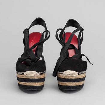 A pair of Gucci wedge shoes size 36.