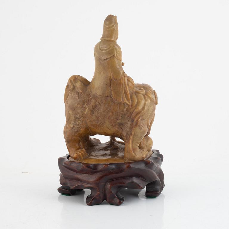 A soapstone guanyin with wooden stand, China, late Qing dynasty/early 20th century.