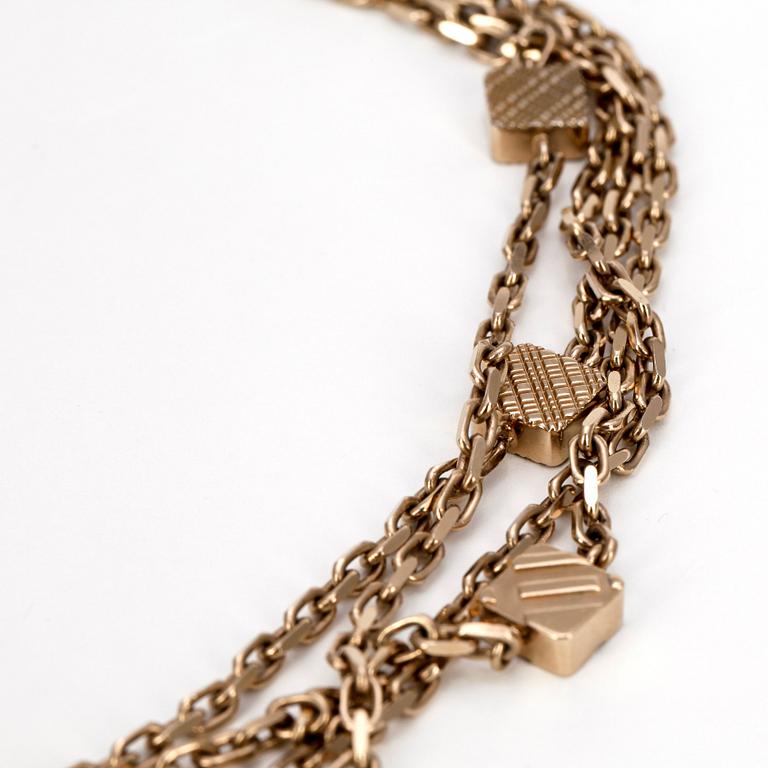 BURBERRY, a gold colored necklace.
