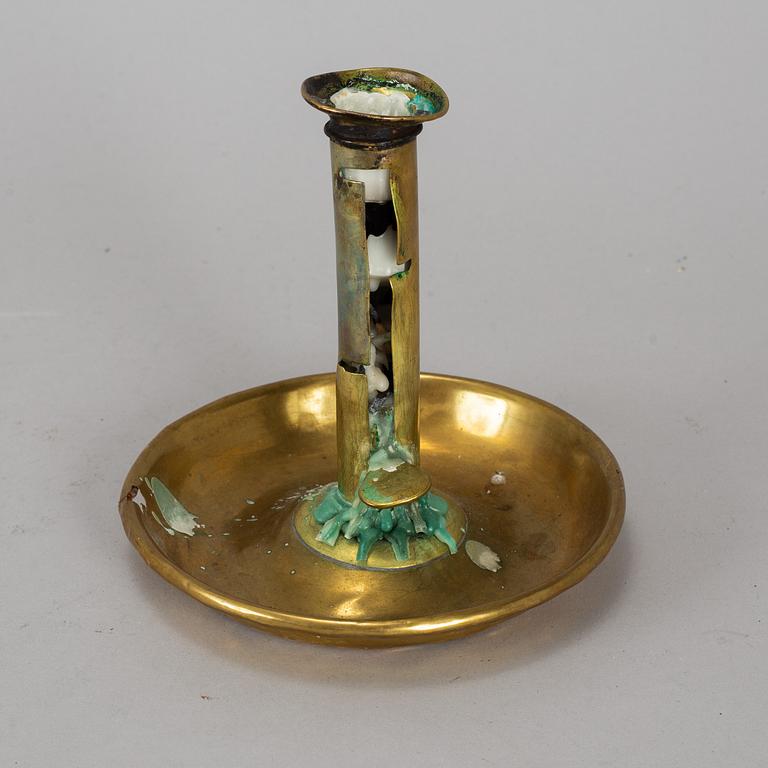 A 19th century brass night light holder.