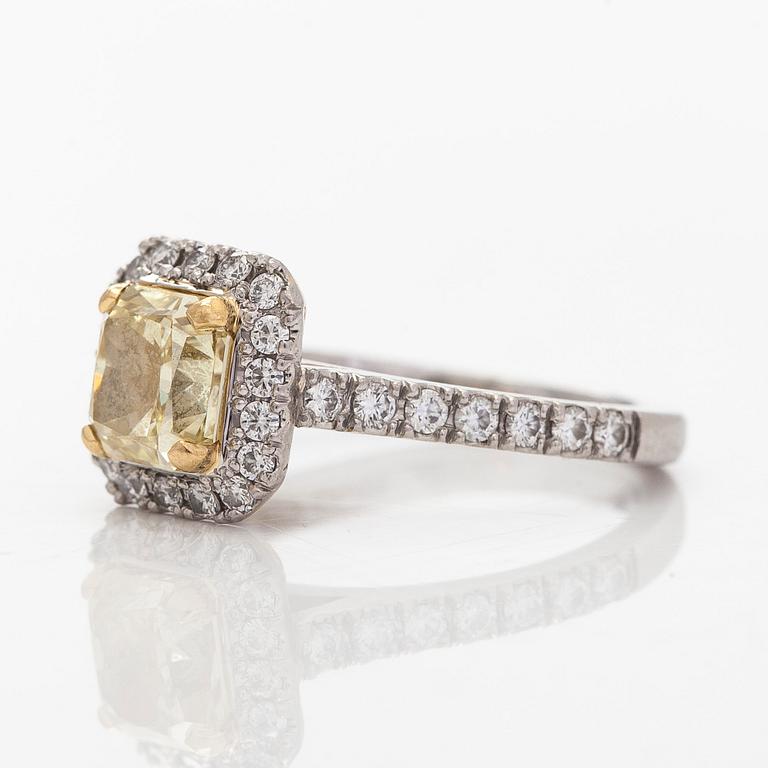 platinum ring with yellow radiant-cut diamond and brilliant cut diamonds.
