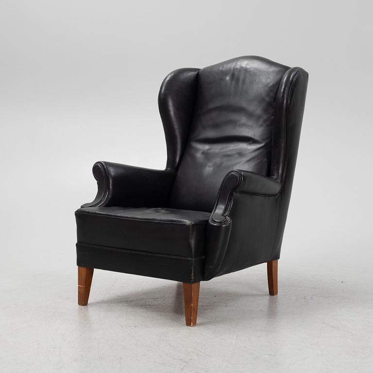 A leather upholstered wingback chair, 20th Century.