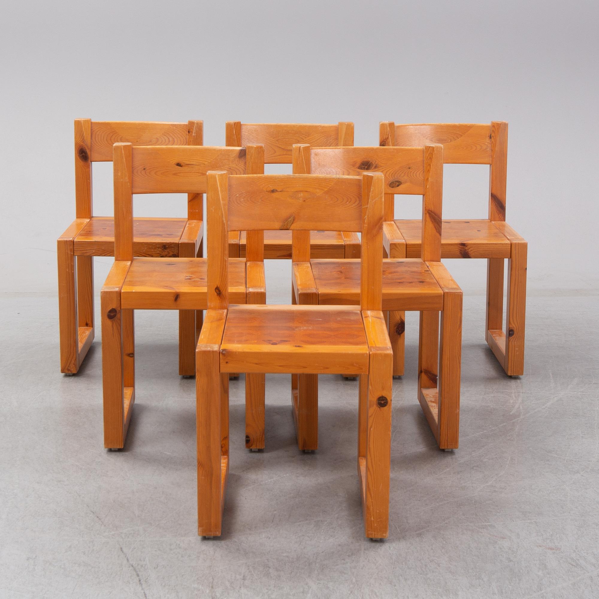 A set of six mid 20th century pine wood chairs with wheels.