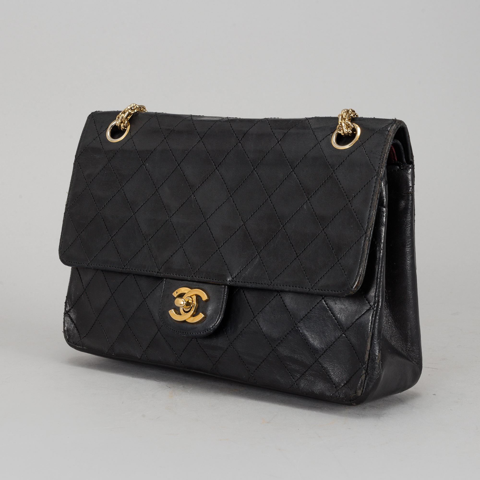 CHANEL, a quilted black leather 'Double Flap Bag'.