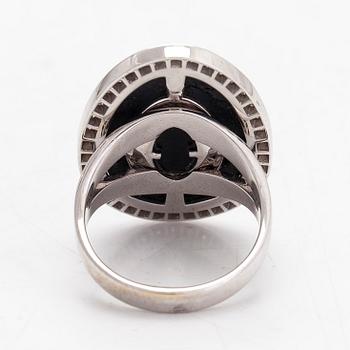 An 18K white gold ring, with diamonds totalling approximately 0.60 ct and onyx by Lanza Carlo, Italy.