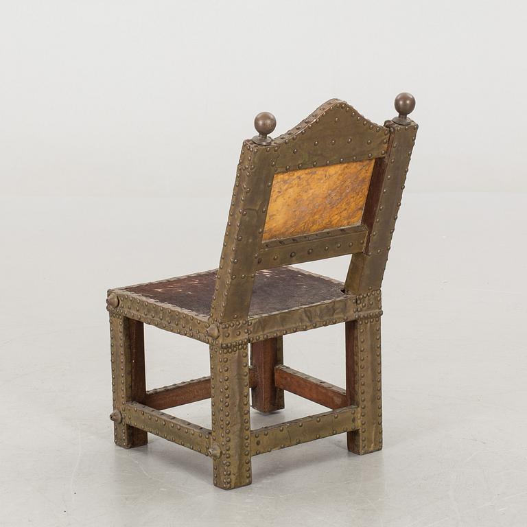 An Ashanti chair, Ghana, hardwood with brass studs, ca 1900.