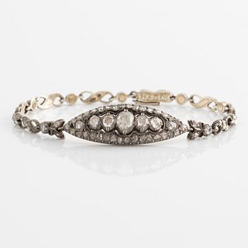 A silver bracelet with rose-cut diamonds.