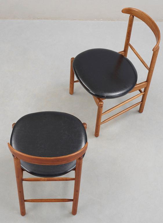 A pair of Greta Magnusson Grossman walnut and artificial leather chairs, for Glenn of California, USA 1950's.