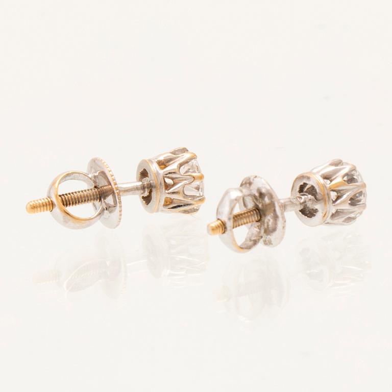 A pair of 14K white gold earrings set with round old-cut diamonds.