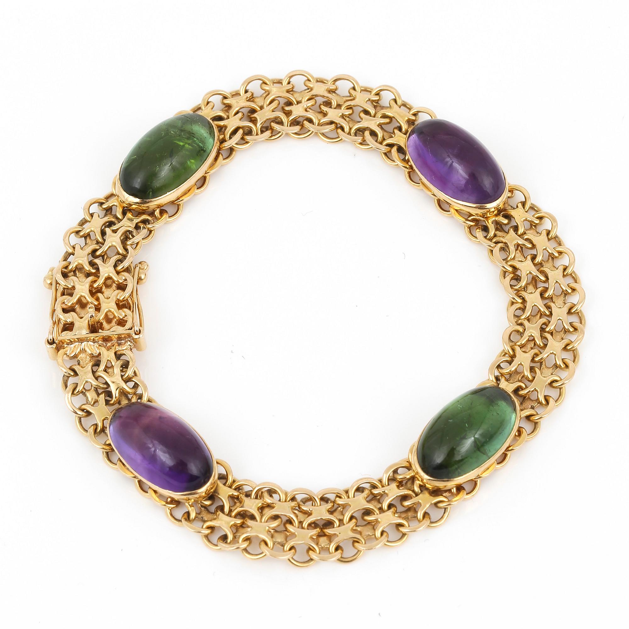 ARMBAND, 18k guld med cabochonslipade turmaliner och ametister, Stockholm, 1963. Vikt ca 23g.