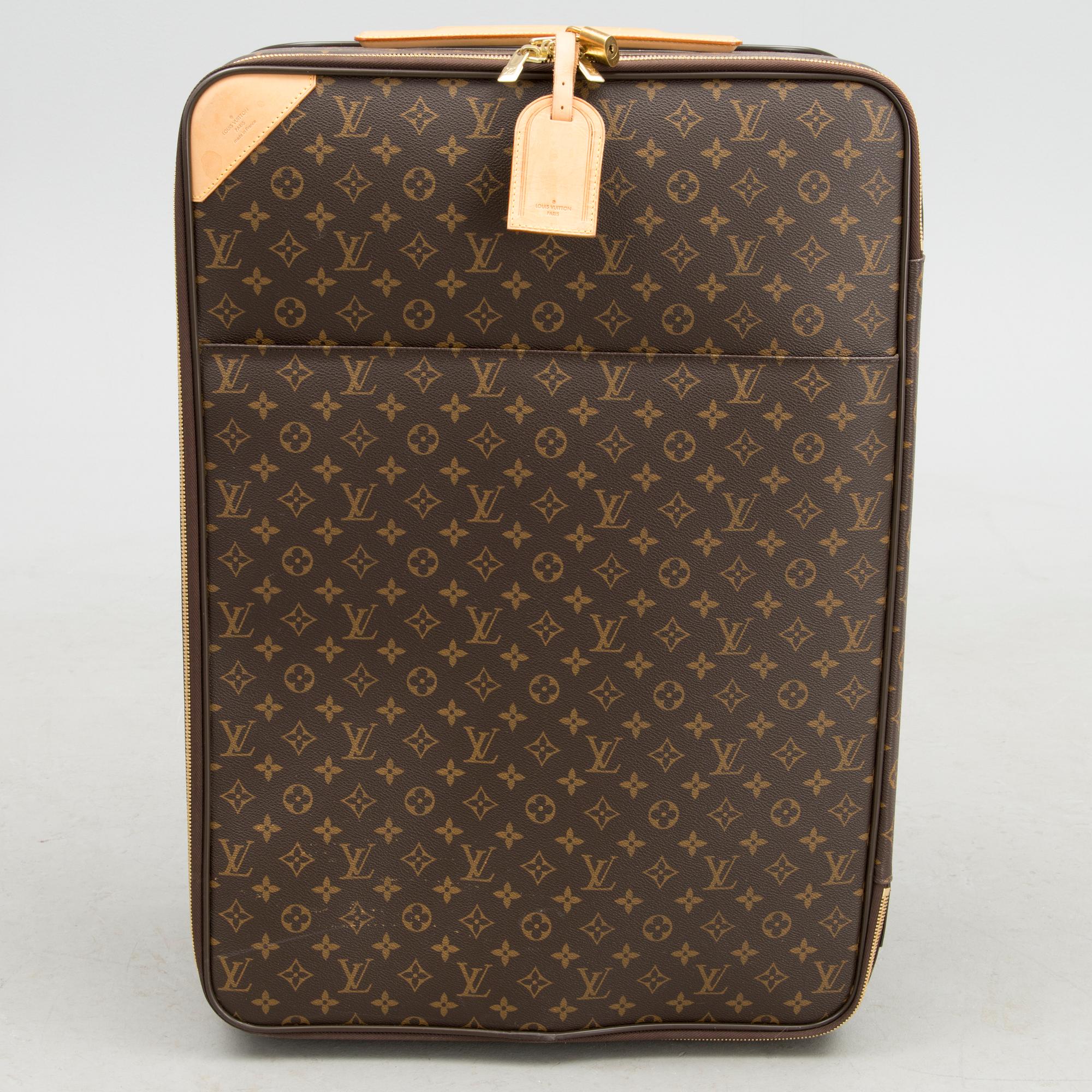 A Monogram Canvas Pégase 65 Suitcase with a Protective Cover.