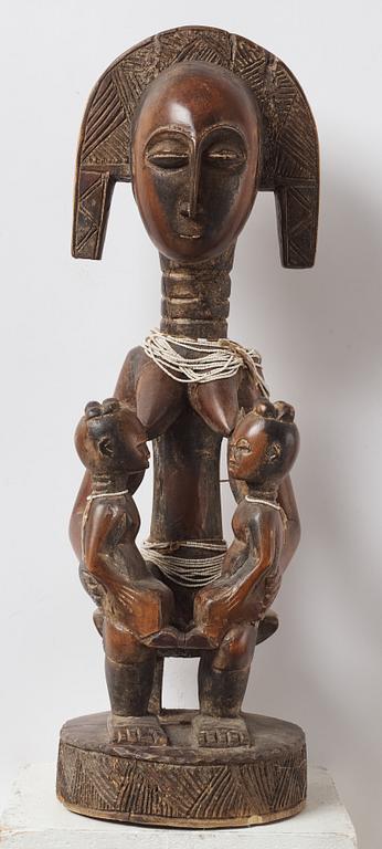A sculptue and two masks reportedly from The Ivory coast, from the second half of the 20:th century.