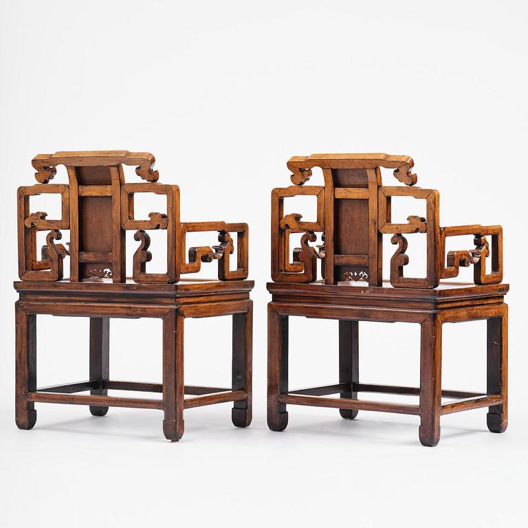 A pair of hardwood armchairs, late Qing dynasty.