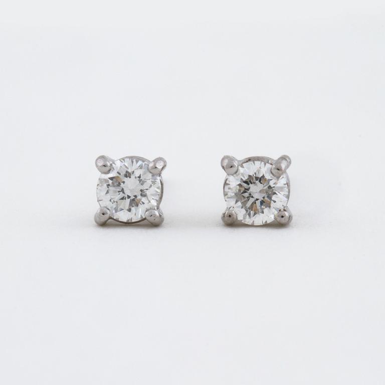 A pair of brilliant cut diamond earrings.