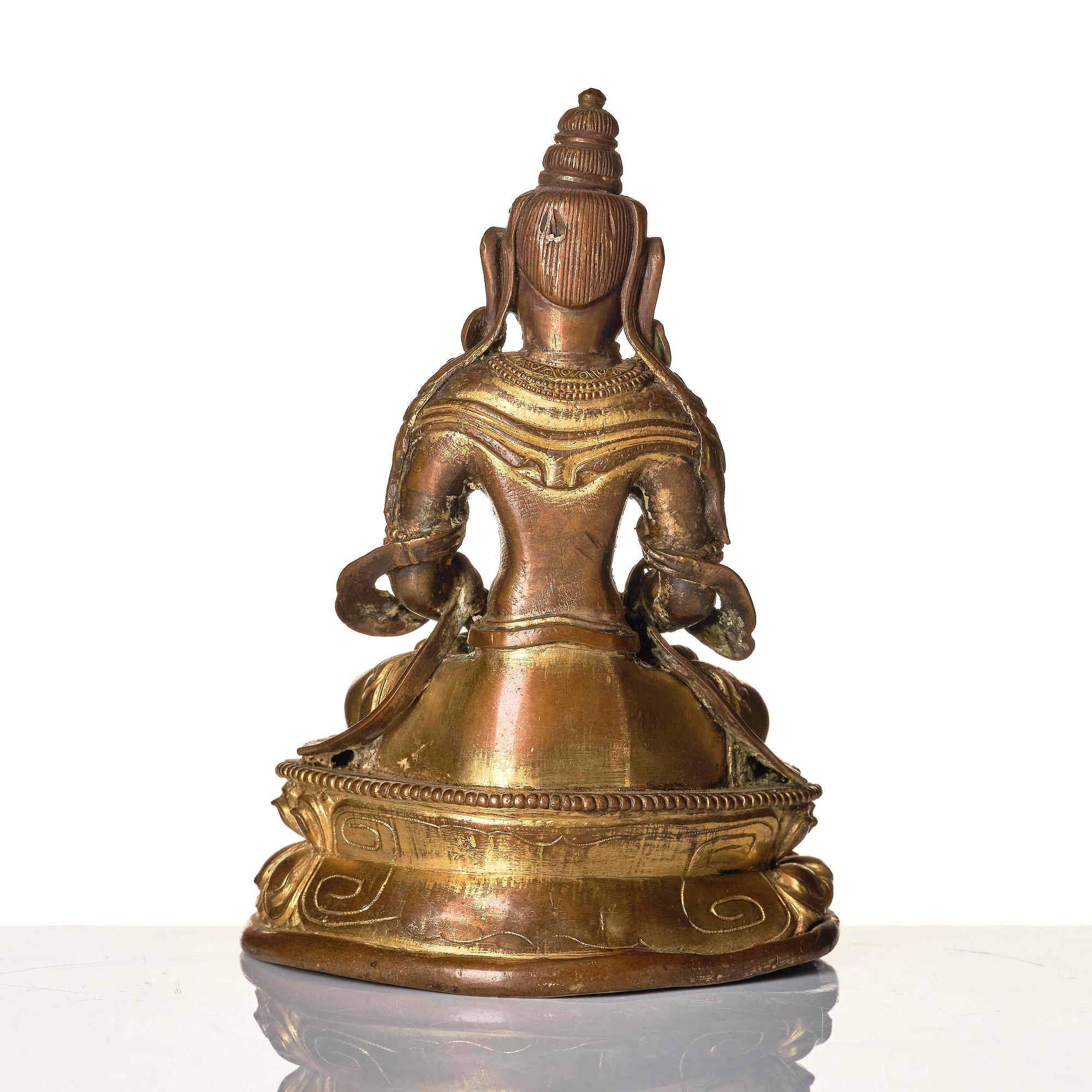 A gilt copper alloy figure of Amitayus, Tibeto-Chinese/Mongolia, 18th century.