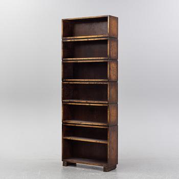 A stained birch shelving system, first half of the 20th Century.