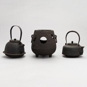 Two teapots and a hibachi brazier, Japan, early/ first half of the 20th century.