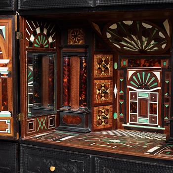 A Louis XIV and Louis XIV-style carved ebony, ivory and tortoiseshell-inlaid cabinet on stand, 17th and 19th century.