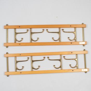 A pair of 'Dekorativ' coat hangers, Skoglunds metallgjuteri, Anderstorp, mid 20th Century.