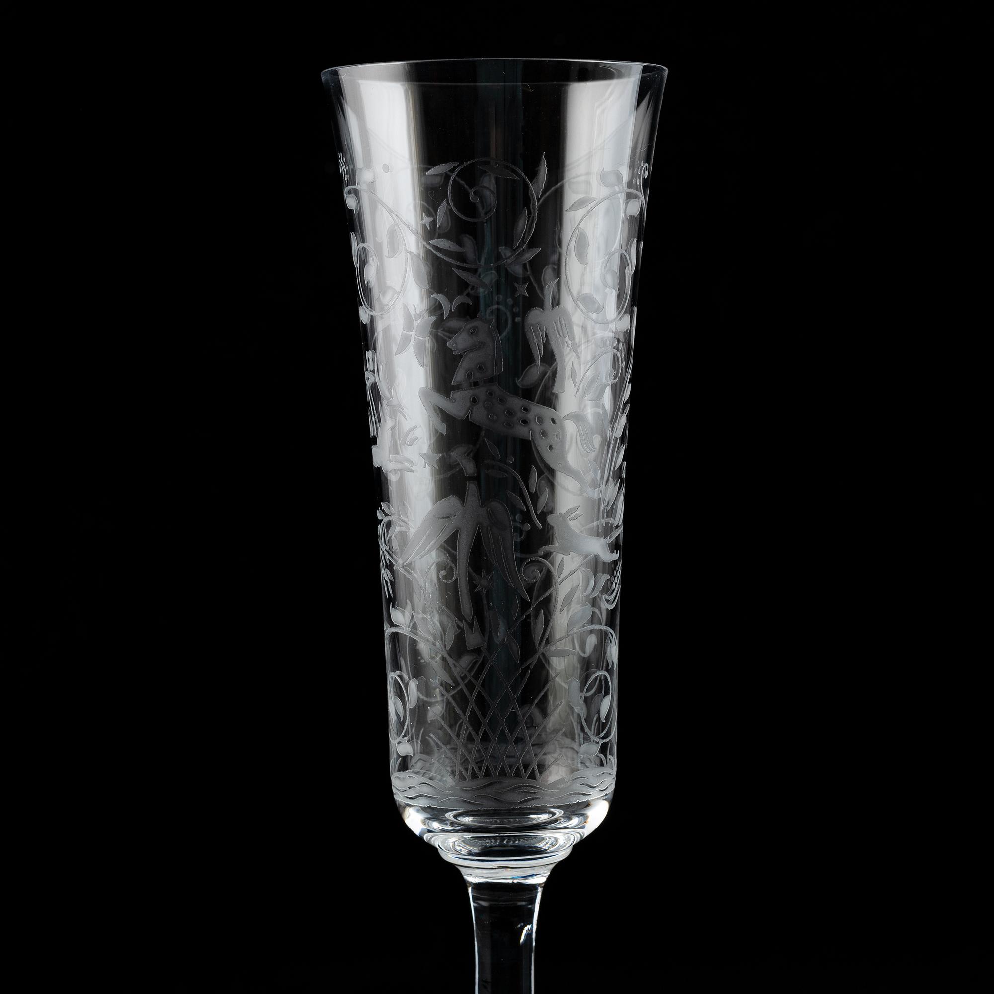 A set of 18 champagne flutes, engraved with animals and leafwork, 20th century Europe .