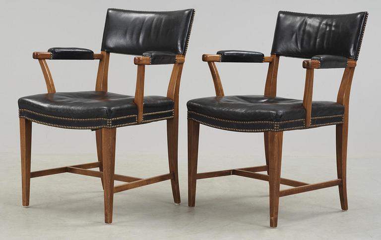 A pair of Josef Frank walnut and black leather armchairs, Svenskt Tenn, model 695.