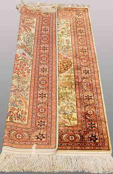 An Oriental figural silk rug, ca 126 x 83 cm.