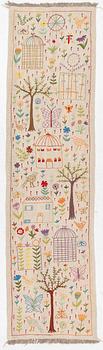 A hand-embroidered kilim runner, c. 300 x 80 cm.