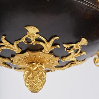 A patinated and ormolu six-light Empire chandelier, Stockholm, first part 19th century.