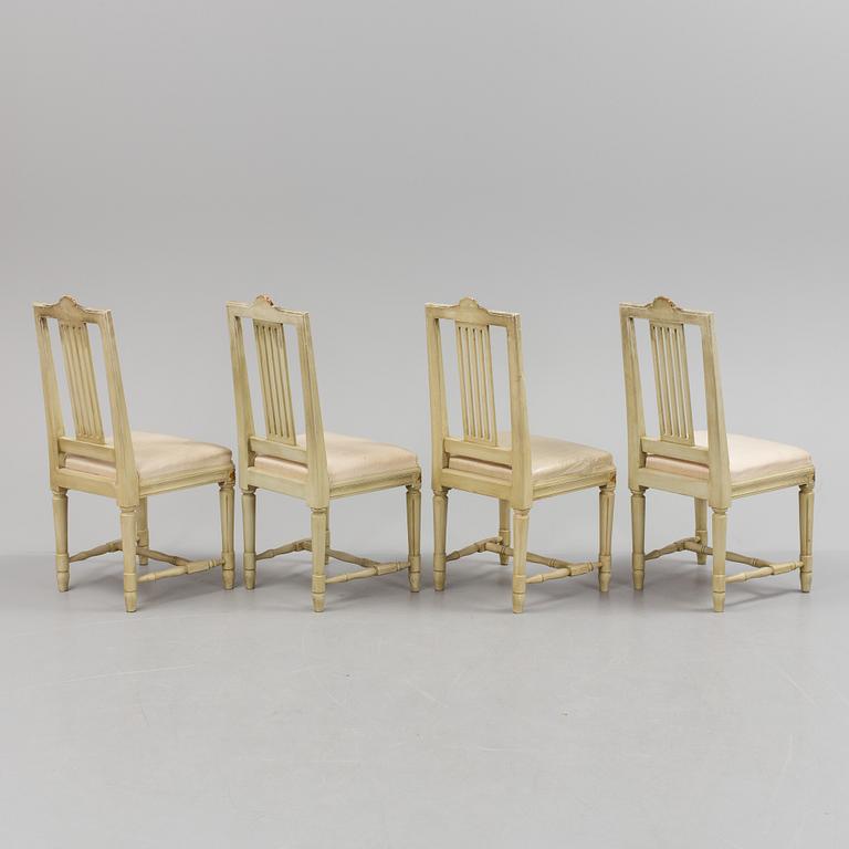 A lot of four mid 20th century Swedish Gustavian style chairs and one dinner table from around year 1900.