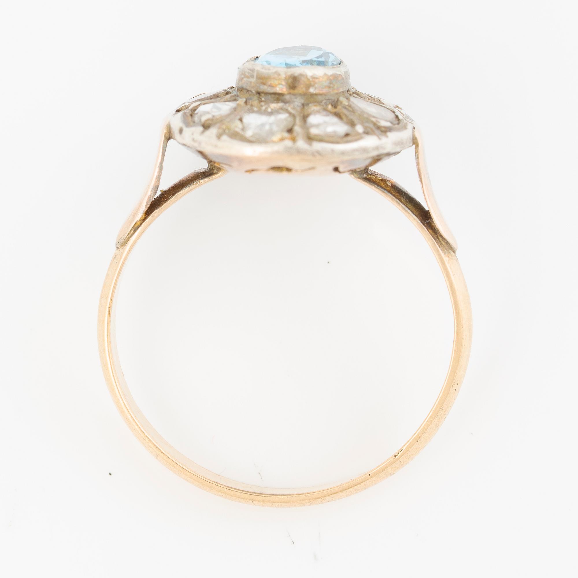Ring in 14K gold with a faceted topaz and rose-cut diamonds.