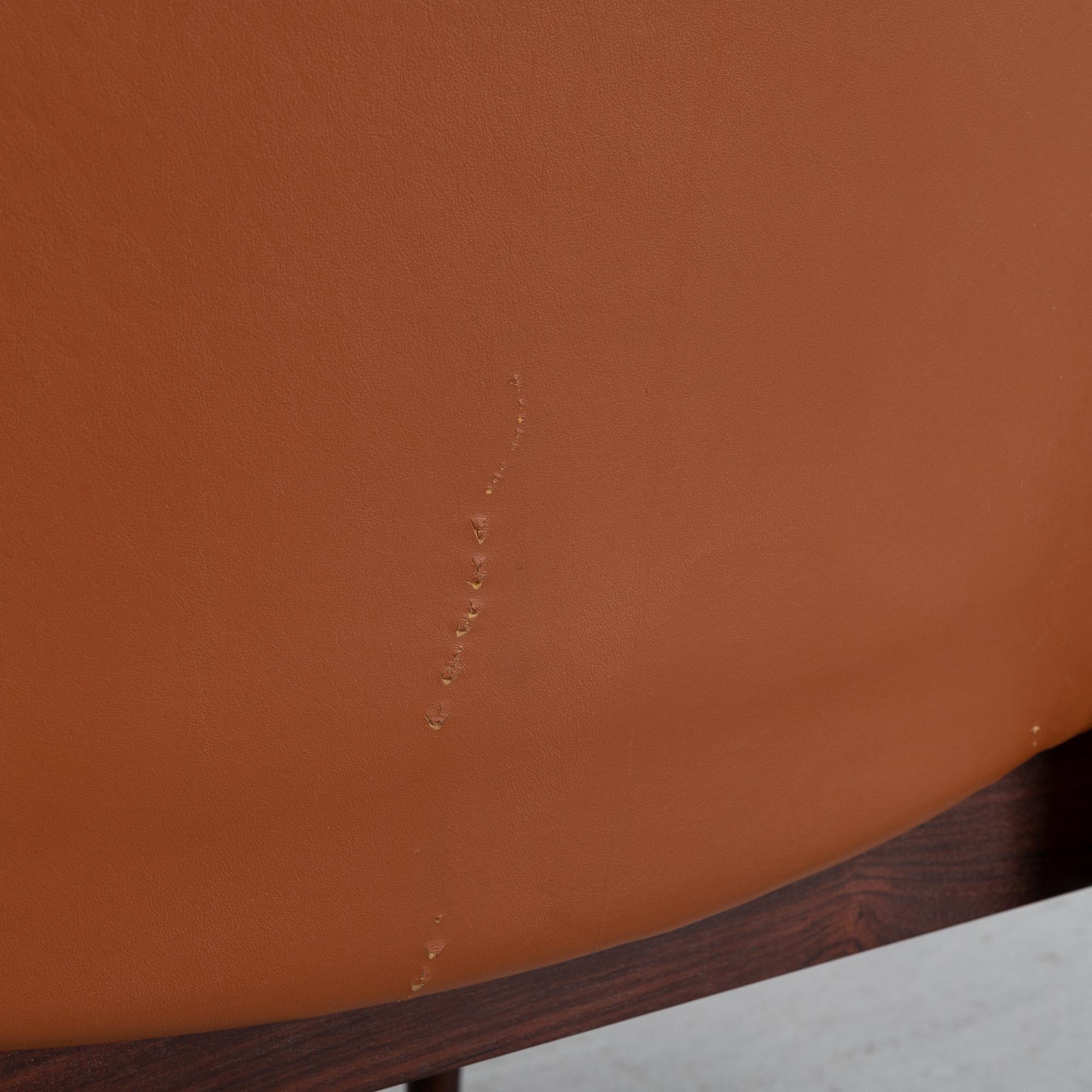 Finn Juhl, a rosewood easy chair, from Cado, Denmark, 1960's/70's.